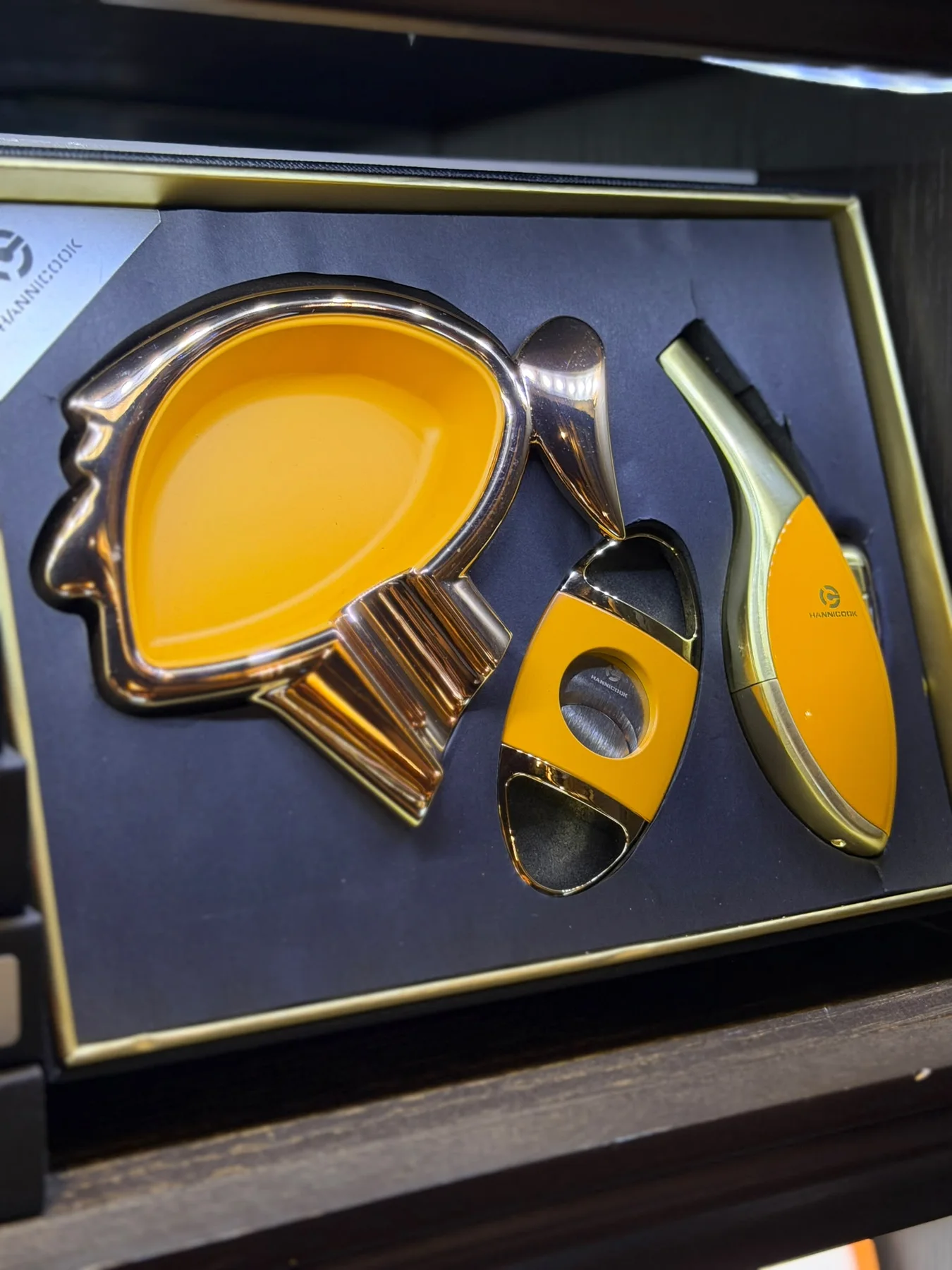 Yellow cigar accessory set with ashtray, lighter, and cutter