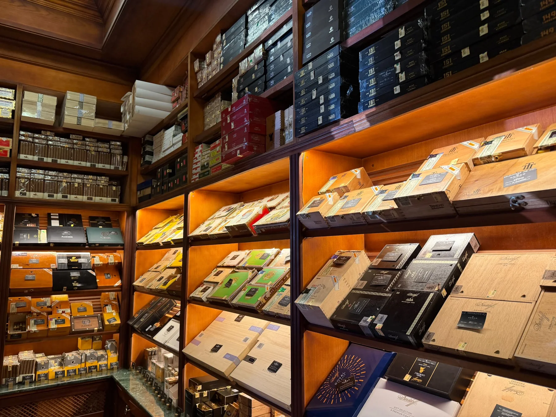 Humidor shelves filled with premium cigar boxes